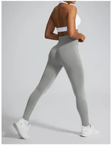 Detailed rear view of grey high-waisted seamless scrunch butt yoga leggings on model