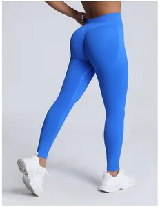 Detail view of high-waisted seamless peach lift yoga leggings in vibrant blue color