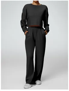 Stylish two-piece black loungewear set featuring a cropped sweatshirt and wide-leg sports pants