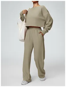 Detail view of a khaki long sleeve cropped sweatshirt and matching loose jogger set.
