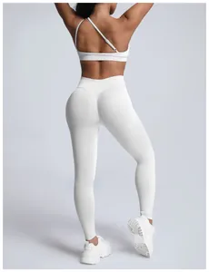 Back view of white seamless one-shoulder sports bra and high-waist yoga leggings