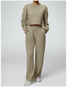 Casual women's two-piece lounge set with cropped sweatshirt and wide-leg sweatpants in tan