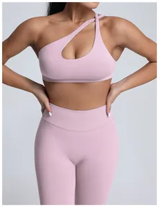 Detail shot of pink seamless yoga set with one-shoulder sports bra and ribbed leggings
