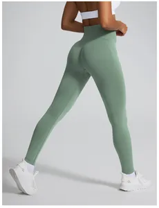 High-waist green seamless yoga leggings with peach butt lifting design back view detail