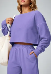 Detailed view of the purple cropped long-sleeve sweatshirt and matching jogger pants set.
