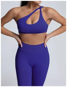 Detailed view of electric blue one-shoulder seamless yoga bra with asymmetric cutout