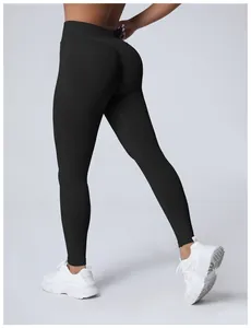 Back view of high-waist seamless black yoga leggings showing peach lift effect and fit
