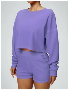Detail view of purple long-sleeved cropped sweatshirt and matching shorts sports set