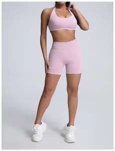 Full-body view of a pink seamless high-waist yoga shorts and sports bra fitness set