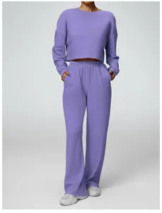 Trendy purple two-piece sports set featuring cropped long sleeve top and wide leg pants