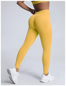 Rear view of yellow high-waisted seamless scrunch butt yoga leggings for fitness