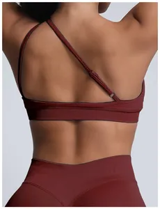 Close-up back detail of a seamless matte nylon sports bra with one-shoulder backless design