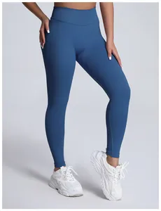 Professional studio shot of high-waisted seamless matte blue yoga leggings on model.