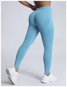 Detail view of light blue seamless high-waisted yoga pants with peach butt lifting design