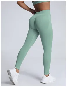 Close-up rear view of mint green seamless yoga leggings with peach lift stitch detail