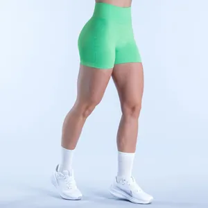Detailed close-up view of vibrant green seamless high-waist fitness shorts on a model