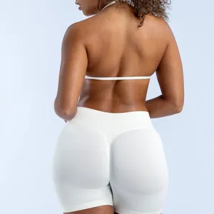 Detailed back view of a seamless halter yoga bra and high-waist shorts set in white.