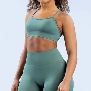 Detailed view of a seamless matte nylon yoga bra in teal featuring delicate straps