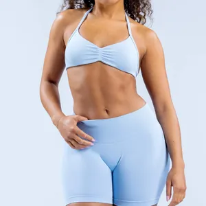 Close-up detail of light blue seamless halter neck sports bra and matching yoga shorts
