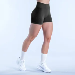 Detailed side view of black seamless high-waist fitness shorts worn by model in studio