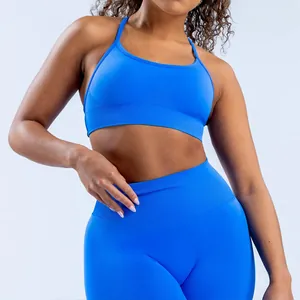 Detail shot of a bright blue seamless matte nylon yoga bra with cross back straps