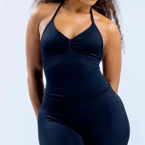 Detalle de top de yoga negro con cuello halter y mallas de compresión a juego