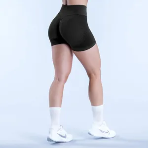Close-up of seamless high-waist black yoga shorts with butt-lifting fit on a model