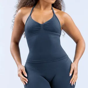Detailed close-up of a dark blue halter neck yoga top with gathered bust and rib texture