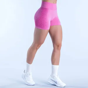Close-up of pink seamless high waist gym shorts with gradient texture and slim fit design.