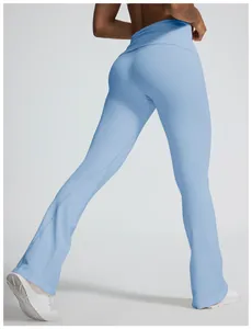 Macro detail of light blue seamless yoga flare pants featuring a fold-over waist design