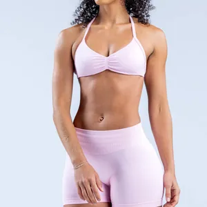Close-up of seamless pink halter yoga sports bra in matte high-stretch nylon fabric