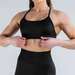 Close-up view of a matte black seamless yoga sports bra showing fabric texture and fit