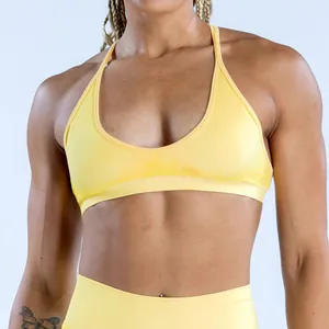 Detail view of a yellow seamless high-elastic yoga sports bra with jacquard texture.