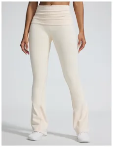 Detail view of cream ribbed yoga flare pants with a fold-over high waistband