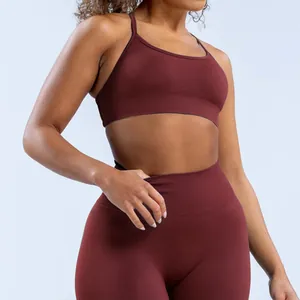 Detailed view of seamless maroon yoga sports bra and high-waisted leggings set on model