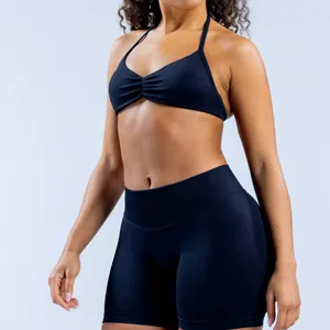 Close-up of black matte nylon seamless yoga halter sports bra and high-waist shorts