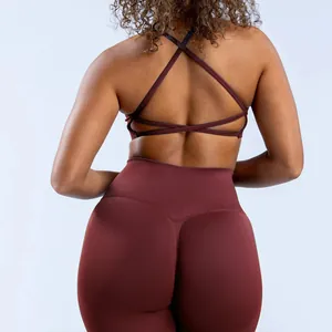 Detailed back view of burgundy cross-back sports bra and high-waisted seamless leggings.