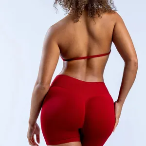 Detail view of a red seamless yoga halter bra with an open back design.