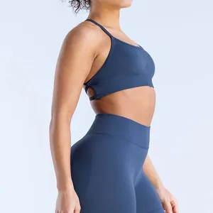 Side view detail of a seamless matte blue yoga bra and matching high-waisted leggings