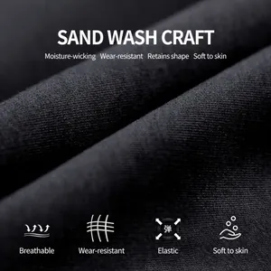 Macro view of black sand-washed seamless yoga fabric with high stretch and breathable texture.