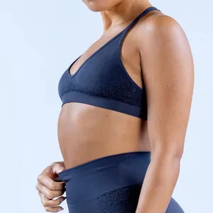 Close-up side view detail of seamless blue yoga bra and high-waisted fitness leggings