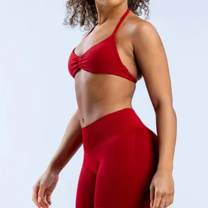 Detail view of red seamless yoga halter bra with high elasticity and matte finish.