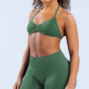 Detail of seamless green yoga set featuring a halter bra and high-waist leggings
