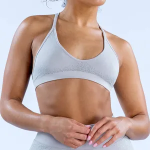 Detail of a light grey seamless sports bra with jacquard texture on the waistband.