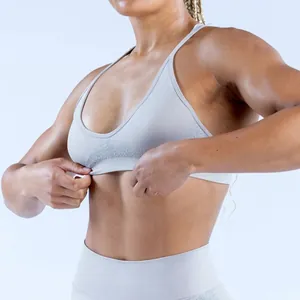 Close-up detail showing the fit of a light grey seamless jacquard sports bra on a model.