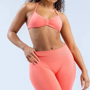 Detailed view of a seamless coral yoga halter bra and matching high-waisted leggings