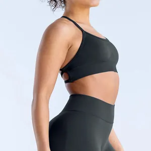 Close-up detail of seamless matte black yoga sports bra with cross-back design