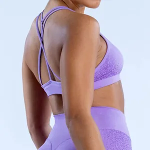 Detail view of purple seamless yoga bra featuring cross-back straps and jacquard texture