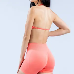 Back view detail of peach seamless halter yoga bra and high waisted gym shorts set