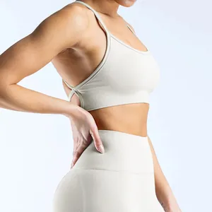 Detail view of seamless beige yoga bra with criss-cross back straps on model
